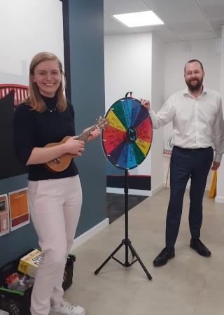 A spinning wheel game demonstration in an office setting